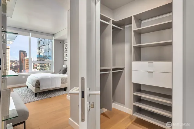 a bedroom with a bed and a window with chair