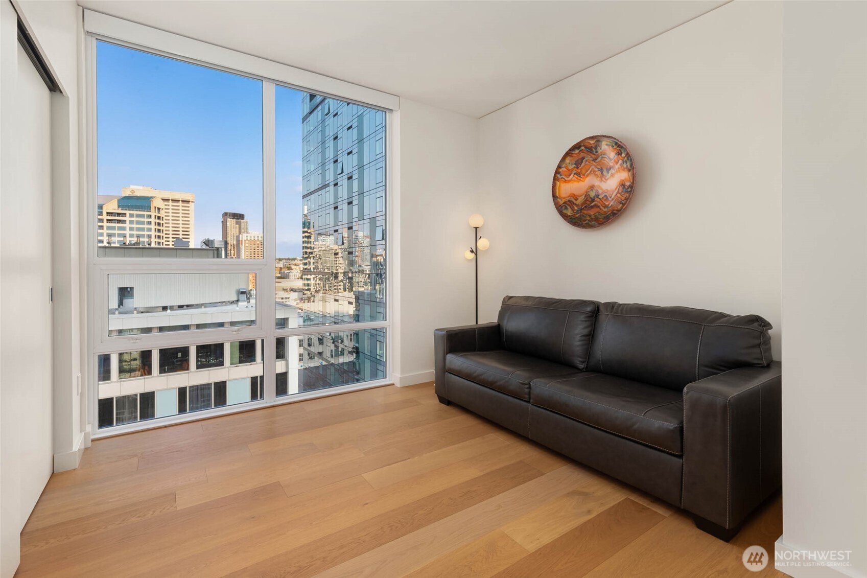 121 Stewart Street, Unit 1701 Seattle, WA 98101 - Photo 17 of 32 a living room with furniture and a large window