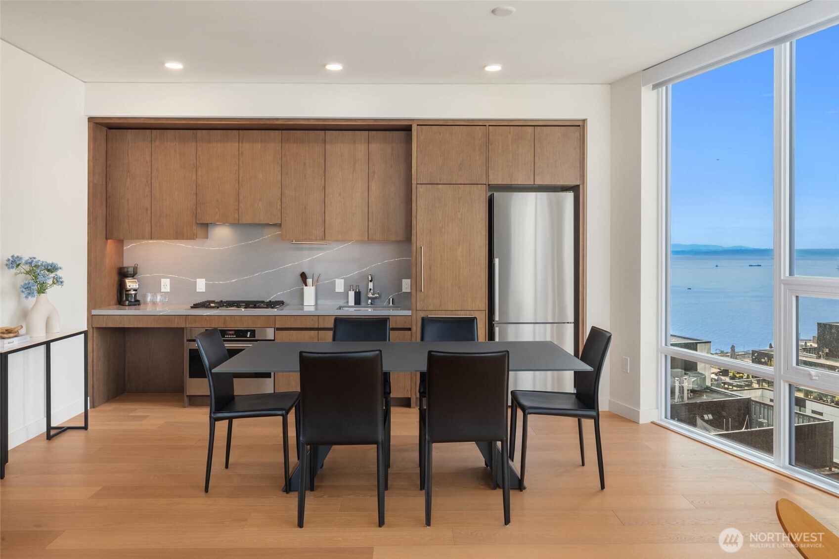 121 Stewart Street, Unit 1701 Seattle, WA 98101 - Photo 2 of 32 a kitchen with a table and chairs in it