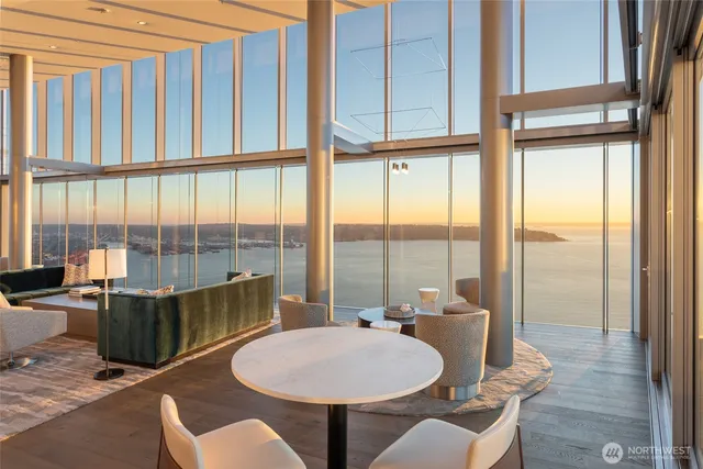 a view of a dining room with furniture large windows and wooden floor