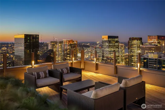 a view of a patio with couches chairs dining table and chairs with wooden floor