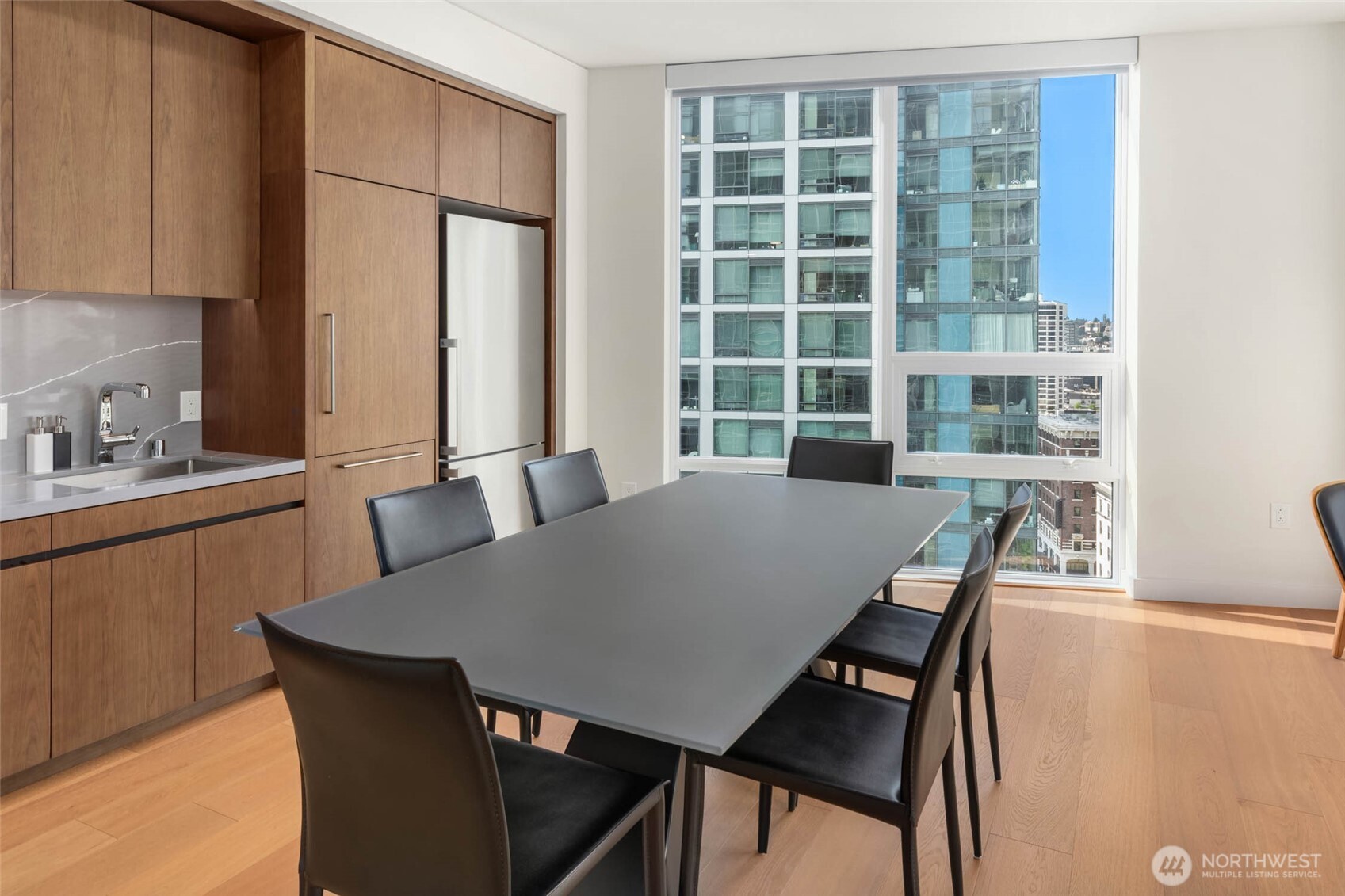 121 Stewart Street, Unit 1701 Seattle, WA 98101 - Photo 4 of 32 a view of a dining room with furniture and window