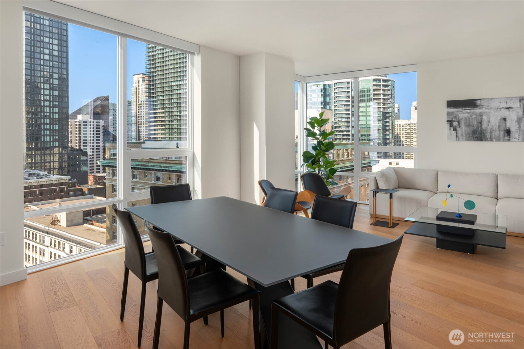 121 Stewart Street, Unit 1701 Seattle, WA 98101 - Photo 7 of 32 a view of a dining room with furniture and a window
