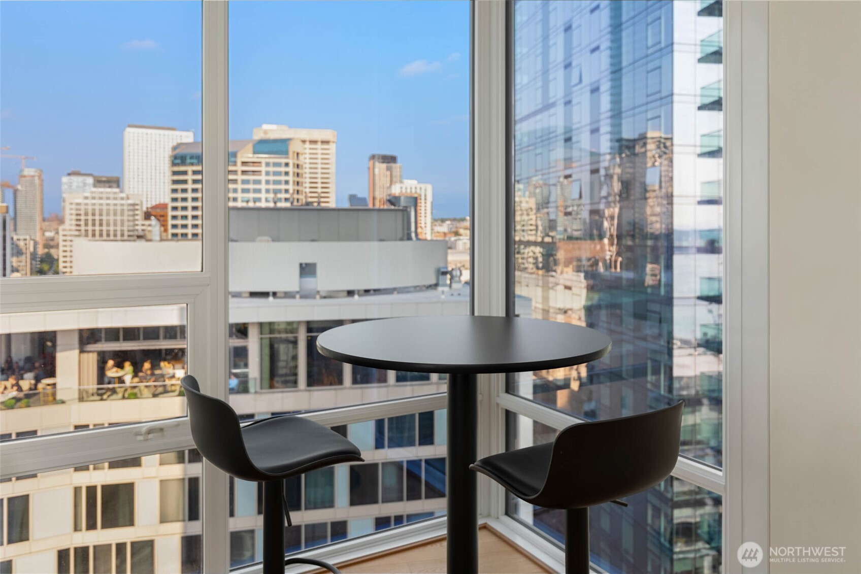 121 Stewart Street, Unit 1701 Seattle, WA 98101 - Photo 8 of 32 a balcony with table and chairs