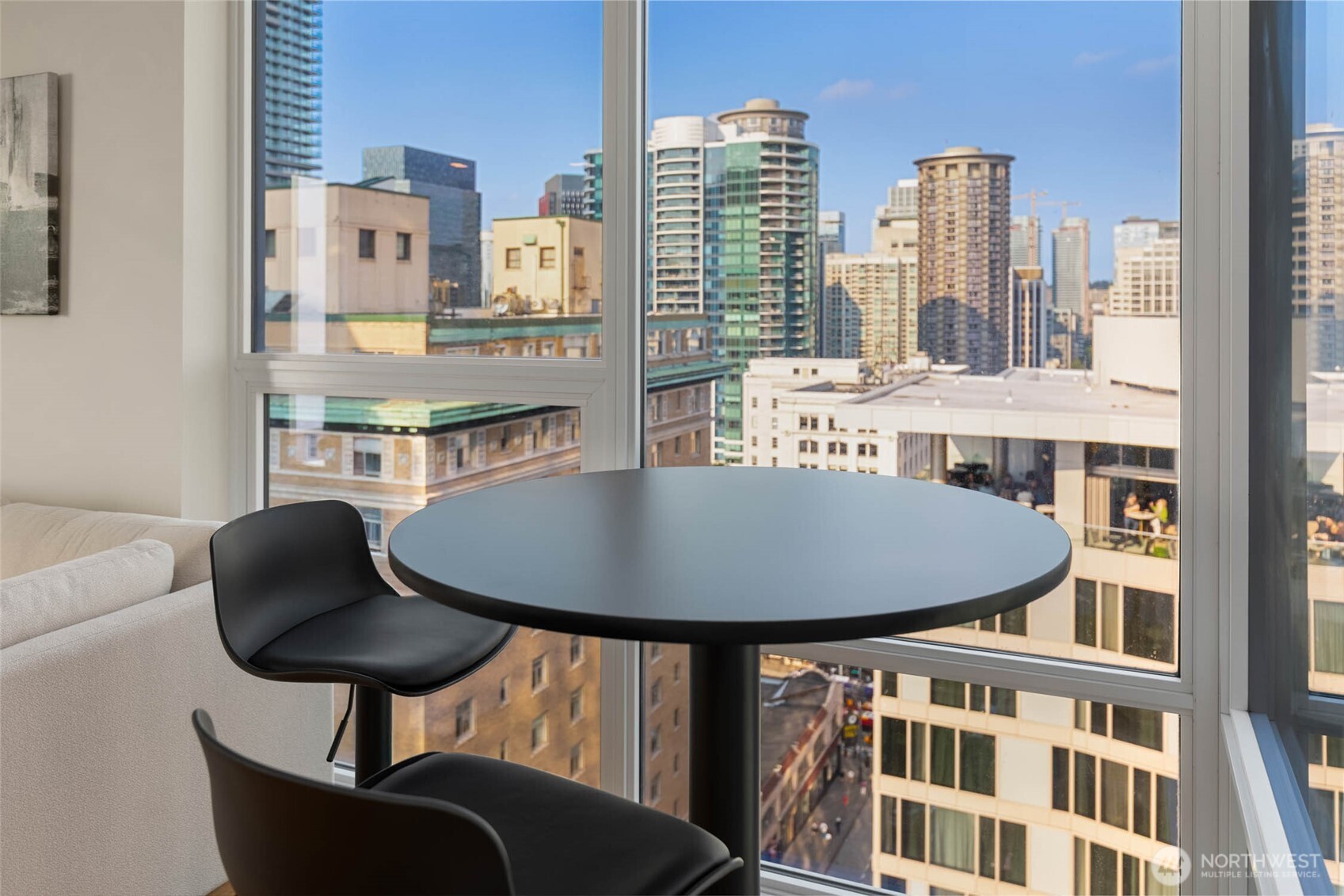 121 Stewart Street, Unit 1701 Seattle, WA 98101 - Photo 9 of 32 a balcony with table and chairs