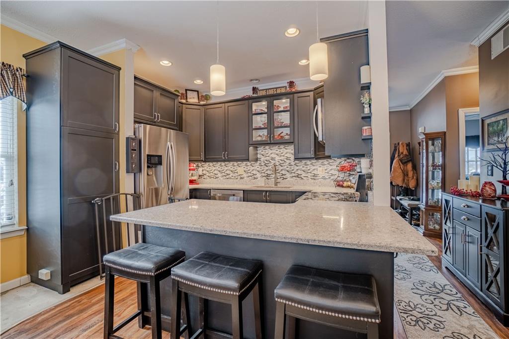 100 Patton Drive Aliquippa, PA 15001 - Photo 12 of 25 a kitchen with stainless steel appliances kitchen island granite countertop a dining table chairs and a refrigerator