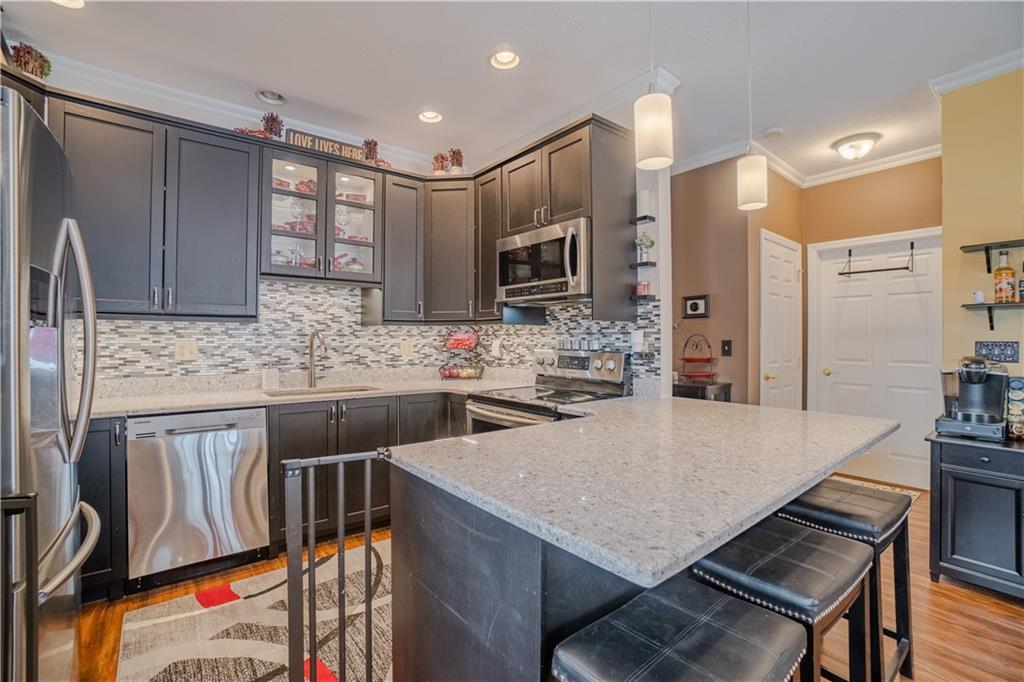 100 Patton Drive Aliquippa, PA 15001 - Photo 13 of 25 a kitchen with stainless steel appliances a stove a sink a microwave a refrigerator and cabinets