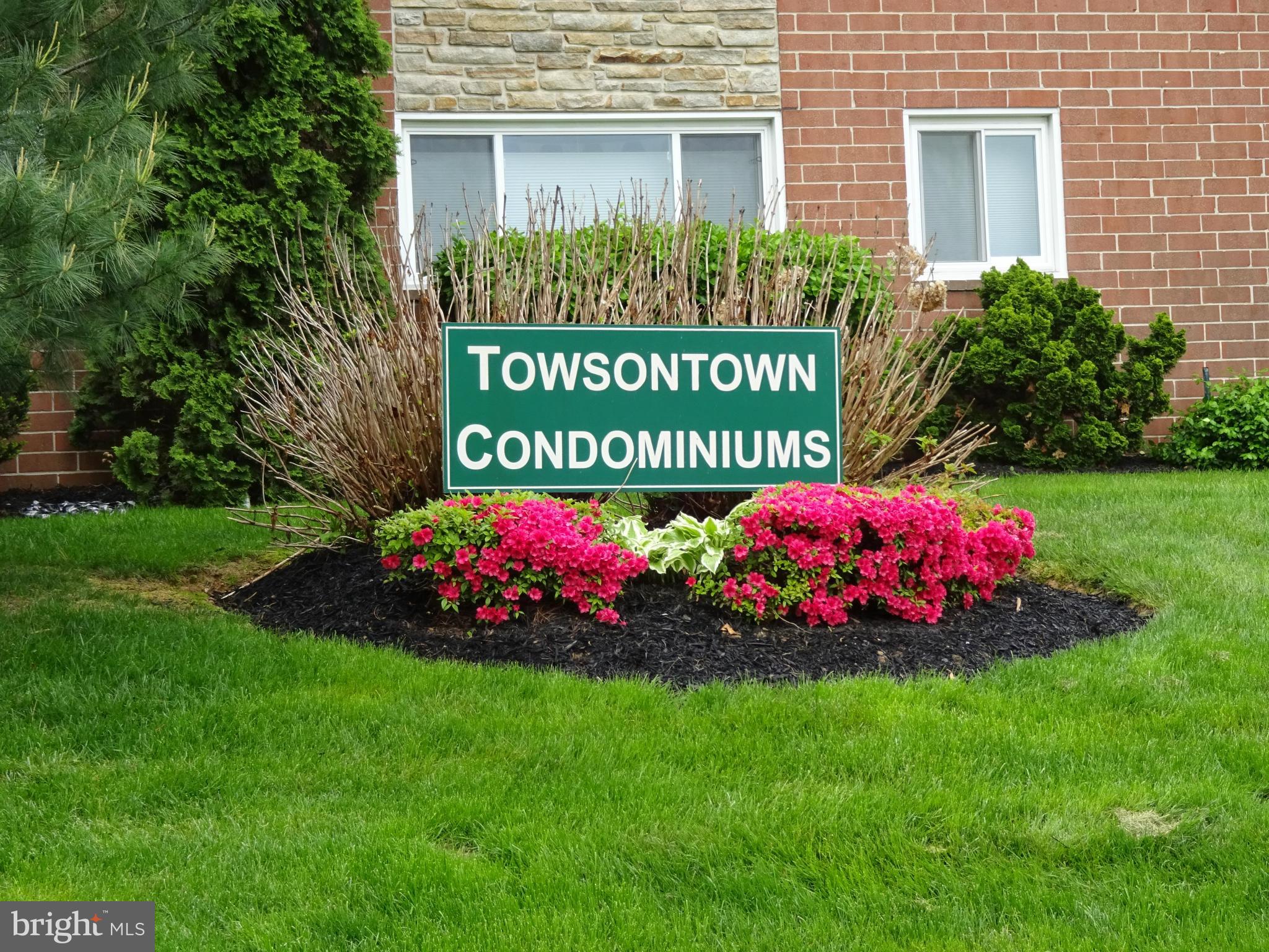 521 Epsom Road, Unit 2B Baltimore, MD 21286 - Photo 1 of 14 a sign that is in front of a brick house
