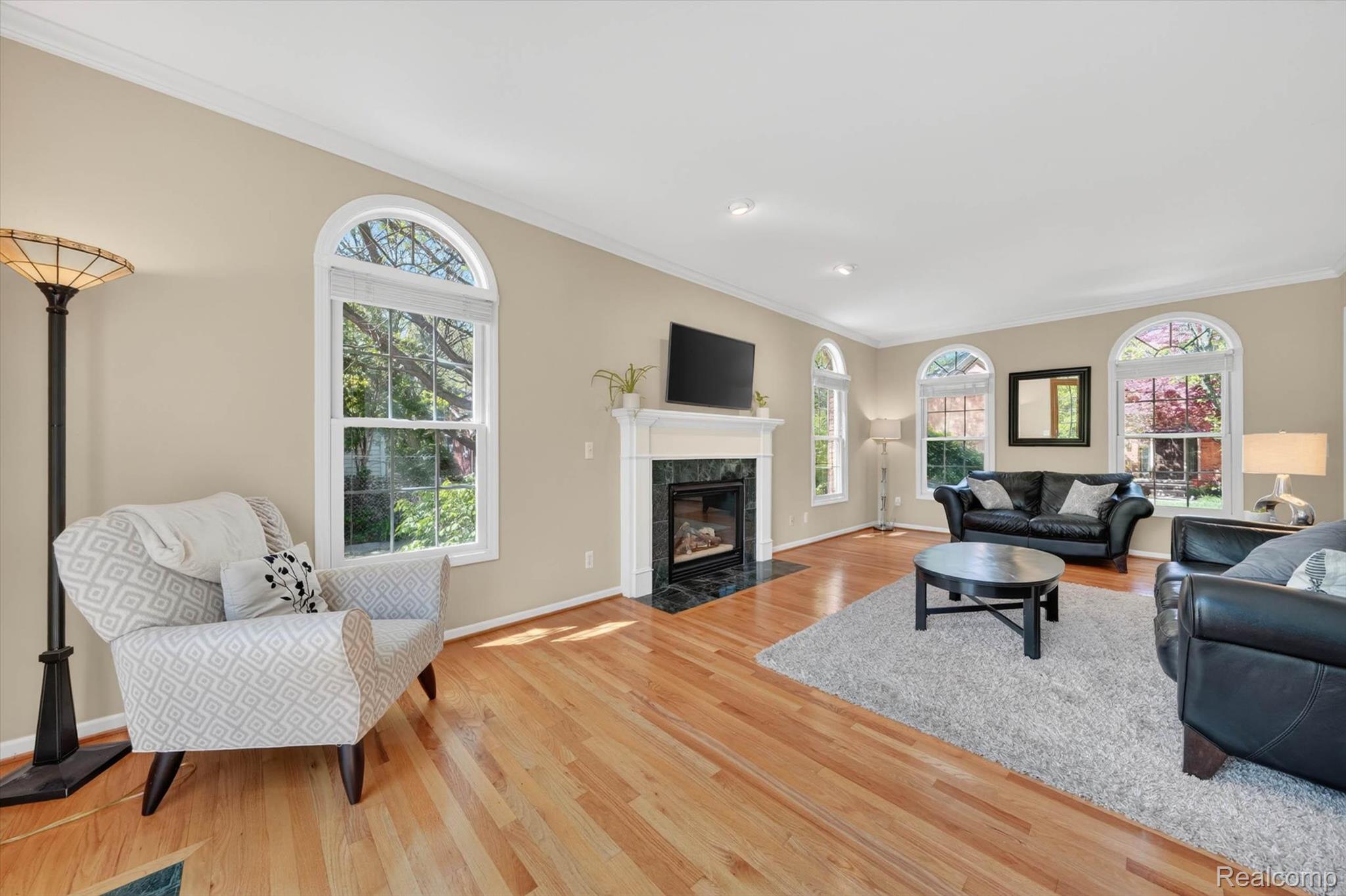 1112 Vernier Road Grosse Pointe, MI 48236 - Photo 10 of 39 Living area with ornamental molding, light wood-type flooring, and a premium fireplace