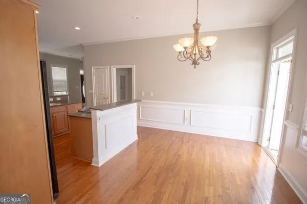 a view of a room with wooden floor and staircase