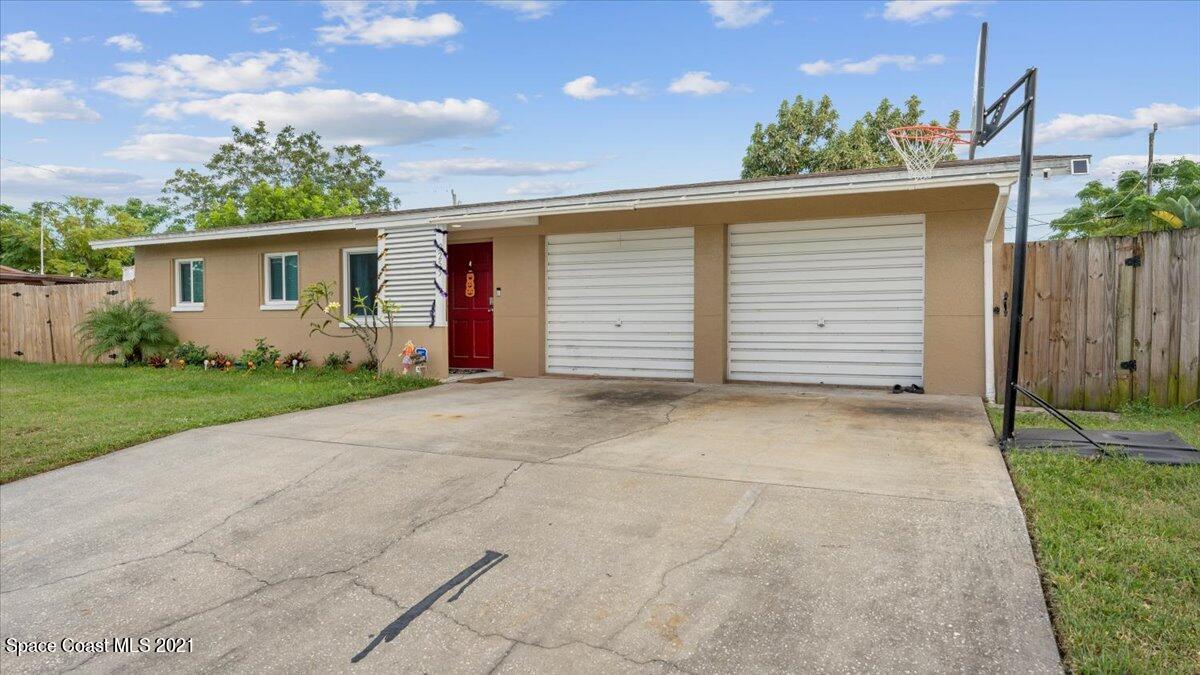 2255 King Richard Road Melbourne, FL 32935 - Photo 1 of 23 a view of a house with a yard and garage