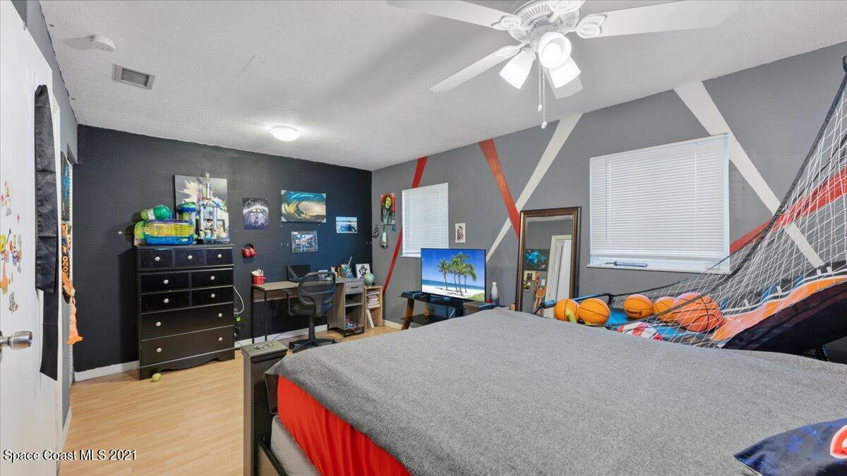 2255 King Richard Road Melbourne, FL 32935 - Photo 11 of 23 a bed room with a bed and a chandelier