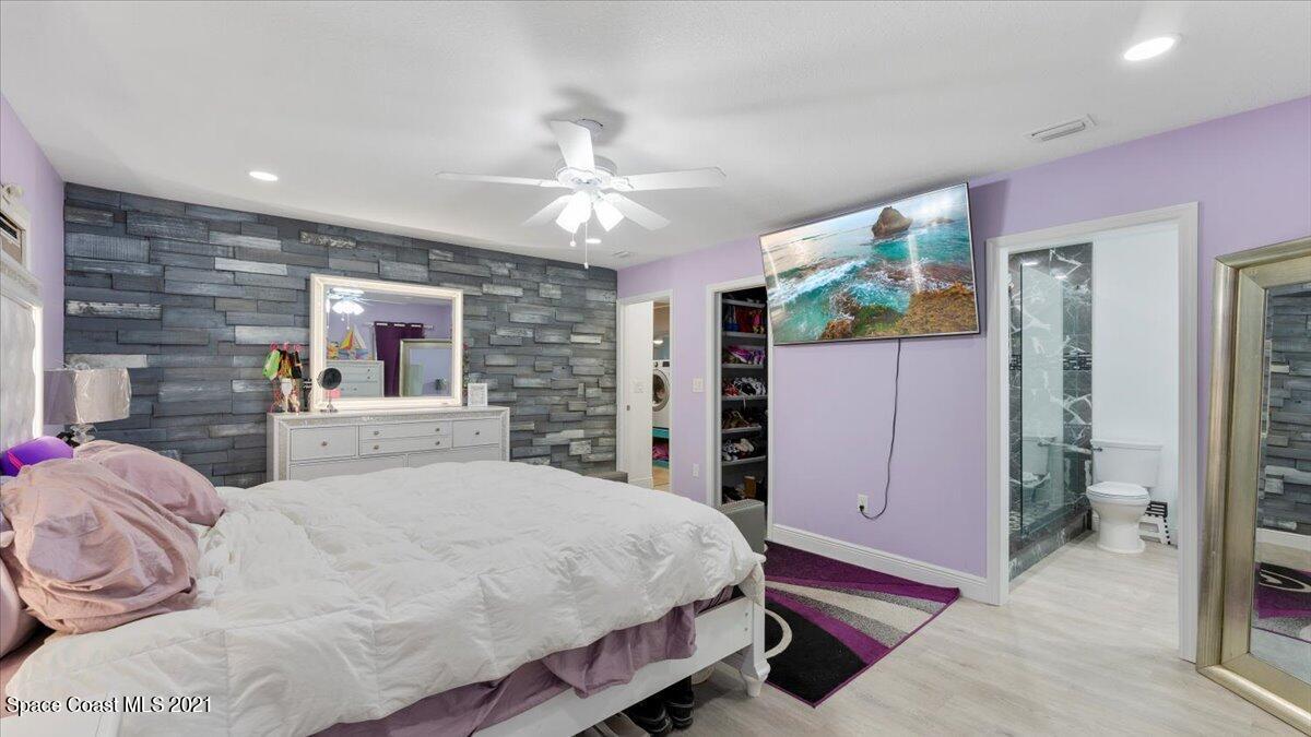 2255 King Richard Road Melbourne, FL 32935 - Photo 15 of 23 a bed room with a bed and a chandelier