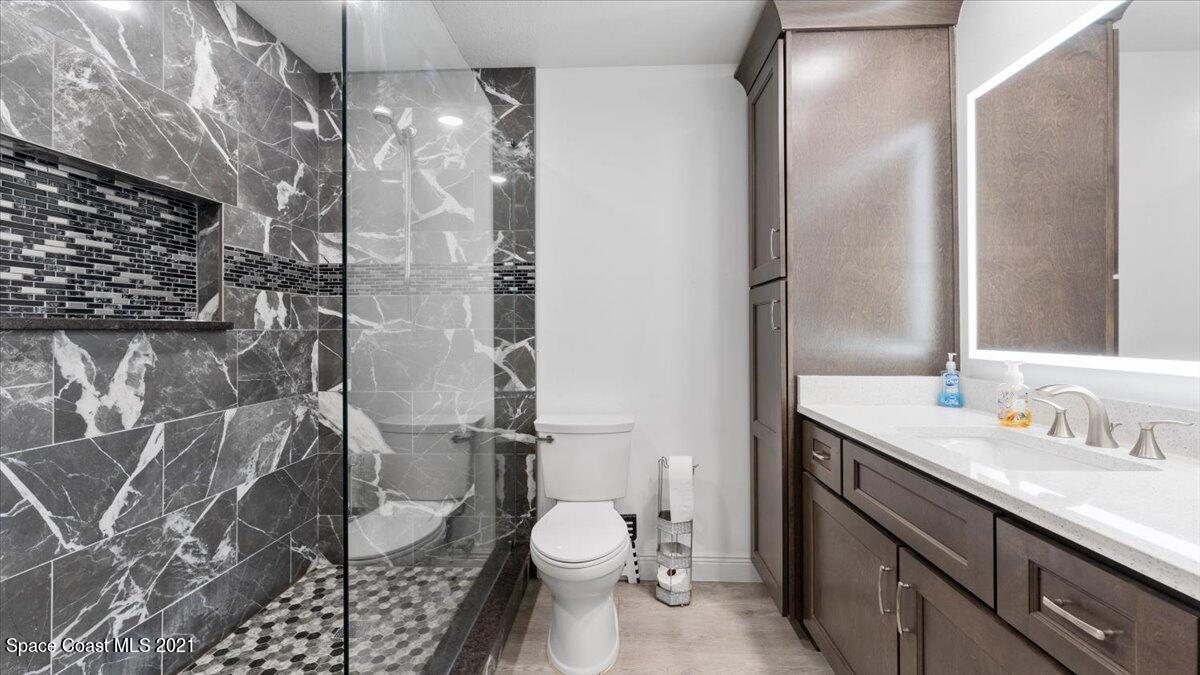 2255 King Richard Road Melbourne, FL 32935 - Photo 16 of 23 a bathroom with a granite countertop sink toilet and shower