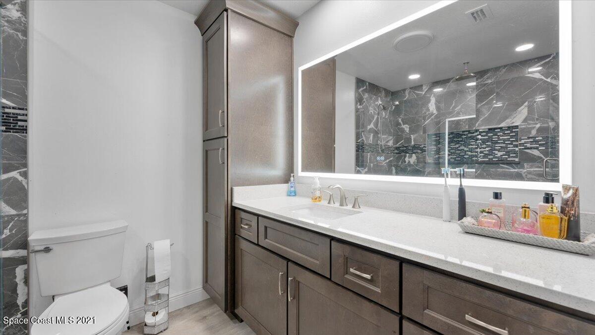 2255 King Richard Road Melbourne, FL 32935 - Photo 17 of 23 a bathroom with a sink double vanity and a toilet