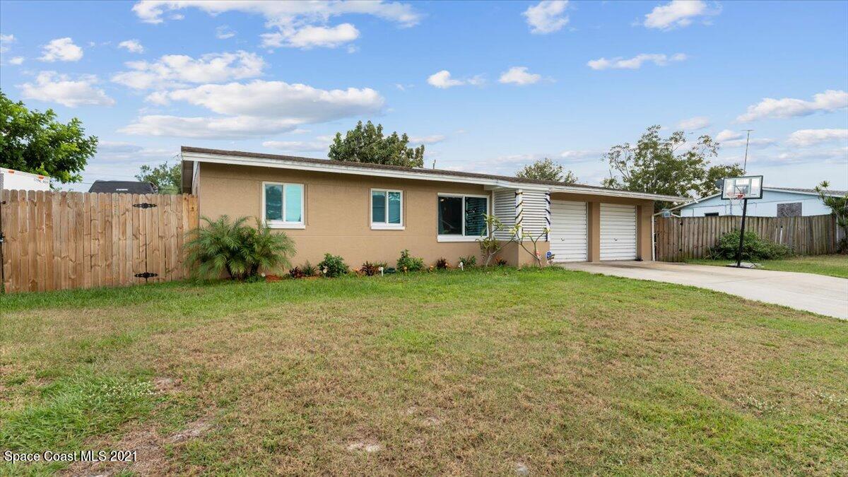 2255 King Richard Road Melbourne, FL 32935 - Photo 3 of 23 a front view of house with yard and green space