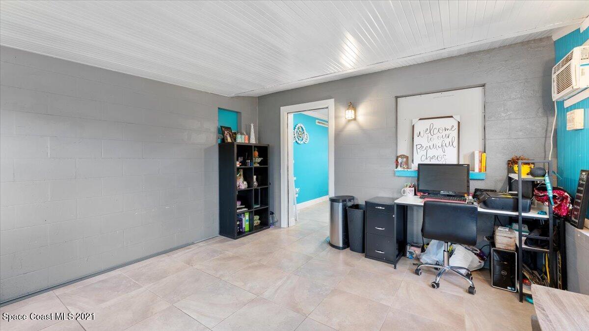 2255 King Richard Road Melbourne, FL 32935 - Photo 22 of 23 a view of a workspace with furniture and a window