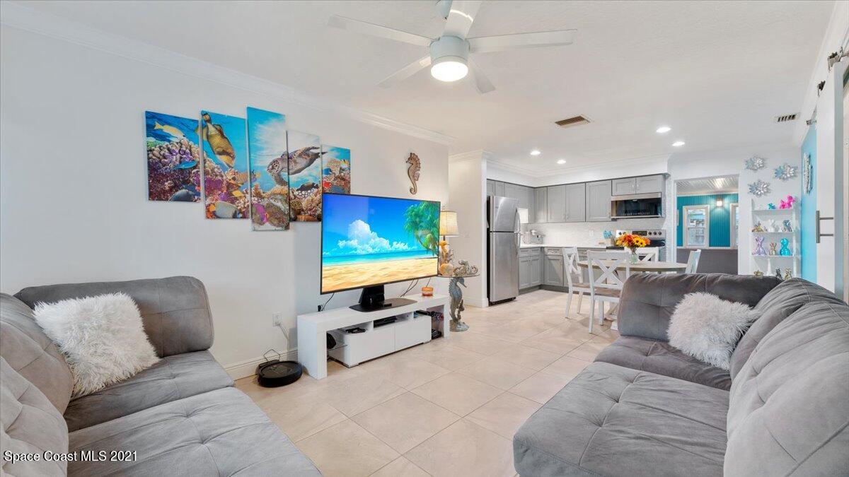 2255 King Richard Road Melbourne, FL 32935 - Photo 4 of 23 a living room with furniture and a flat screen tv