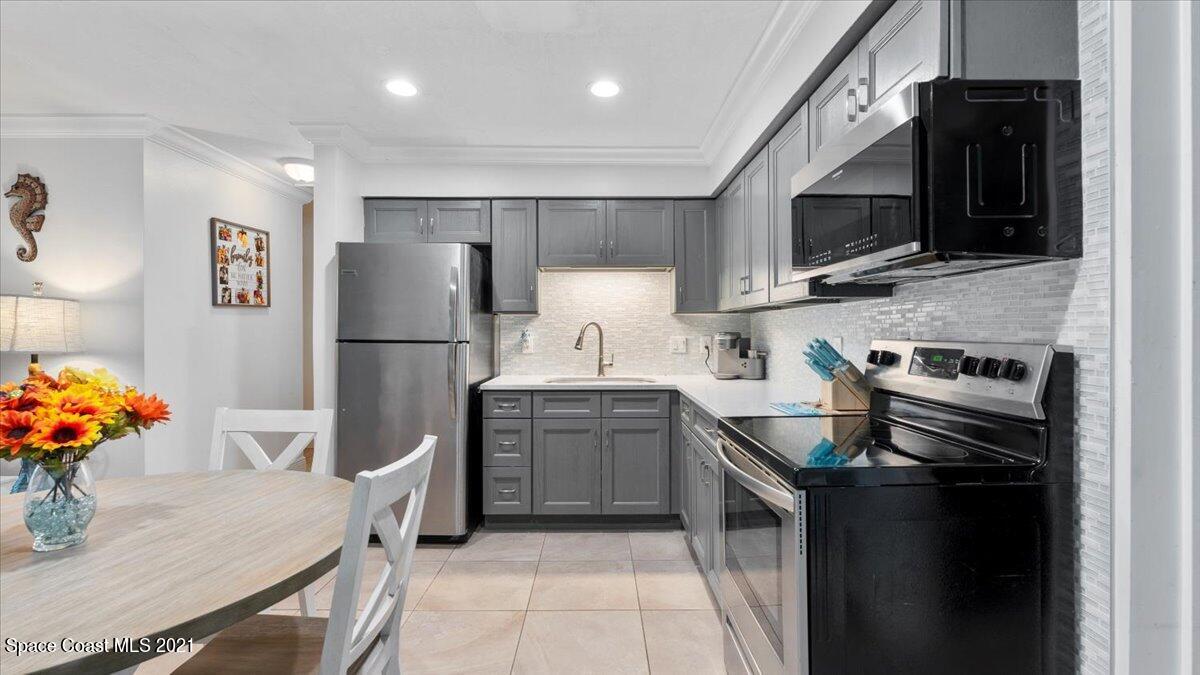 2255 King Richard Road Melbourne, FL 32935 - Photo 7 of 23 a kitchen with stainless steel appliances a refrigerator sink and microwave