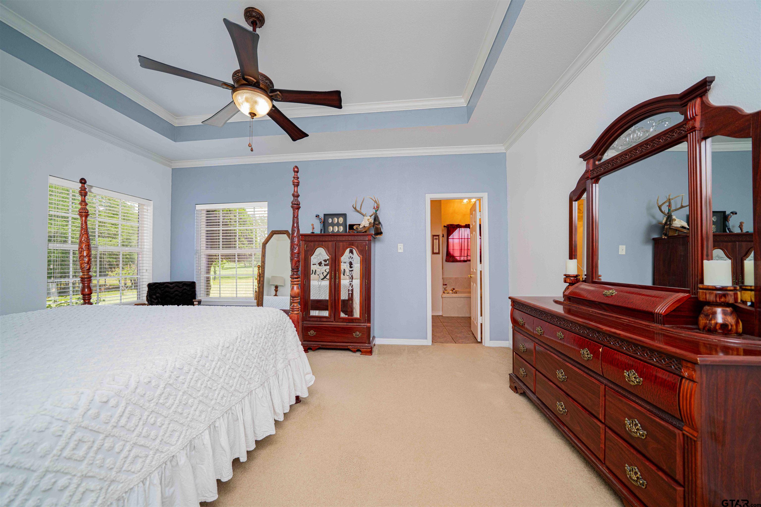 1855 Phillips Springs Road Gladewater, TX 75647 - Photo 15 of 36 a bedroom with a bed and a chandelier