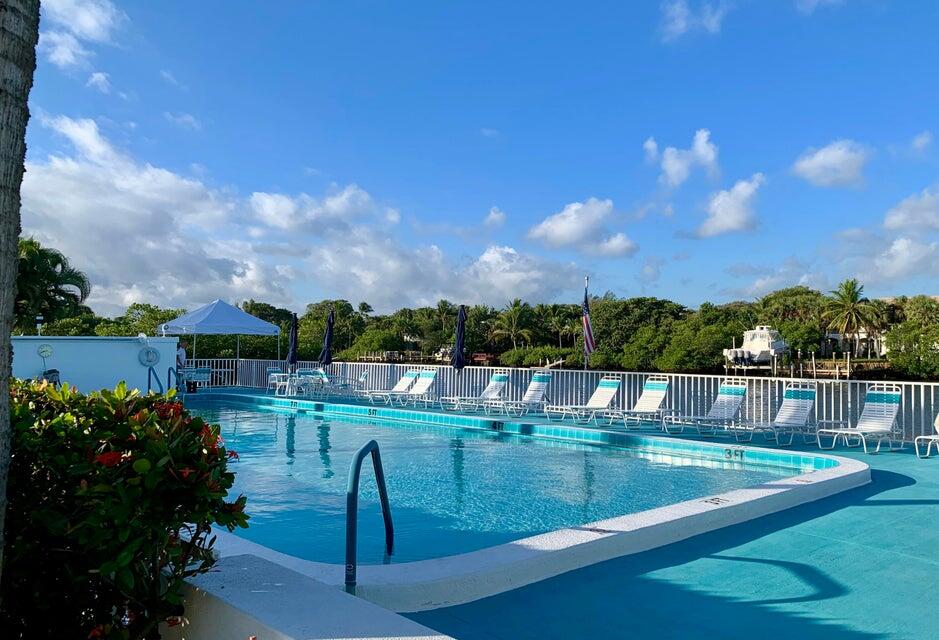 4001 South Ocean Boulevard, Unit 304 South Palm Beach, FL 33480 - Photo 1 of 14 a view of a swimming pool with a yard
