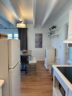 4001 South Ocean Boulevard, Unit 304 South Palm Beach, FL 33480 - Photo 5 of 14 a kitchen with a refrigerator and a table