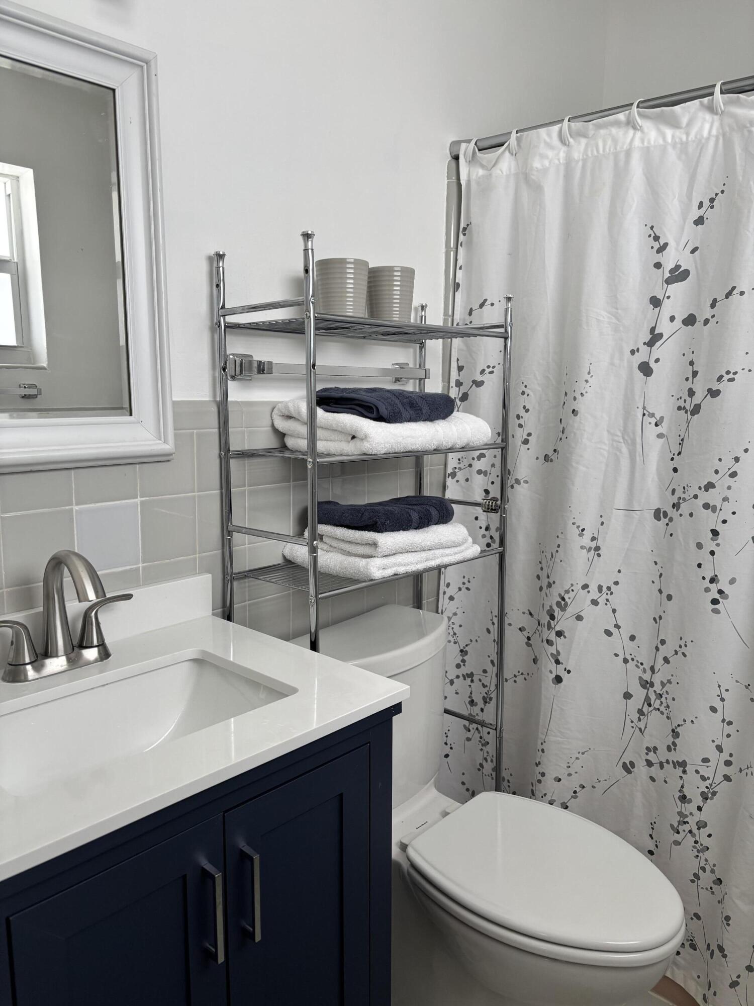 4001 South Ocean Boulevard, Unit 304 South Palm Beach, FL 33480 - Photo 8 of 14 a bathroom with a sink a toilet and shower