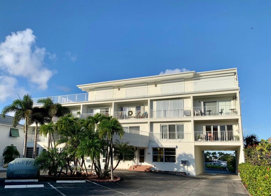 4001 South Ocean Boulevard, Unit 304 South Palm Beach, FL 33480 - Photo 10 of 14 a front view of a building with plants