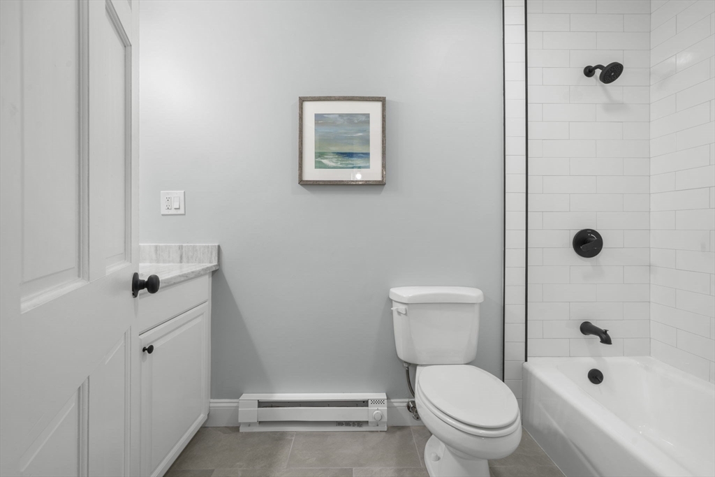 71 School Street, Unit 71 Acton, MA 01720 - Photo 17 of 38 a white toilet sitting next to a bathroom sink