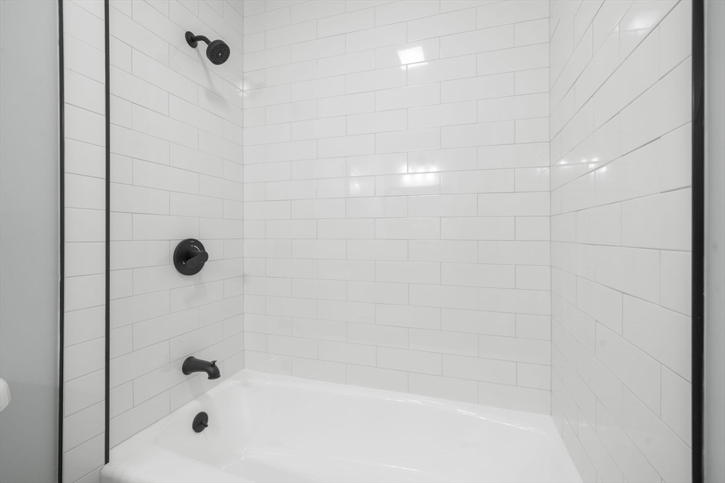 71 School Street, Unit 71 Acton, MA 01720 - Photo 18 of 38 a bathroom with a shower and a bathtub