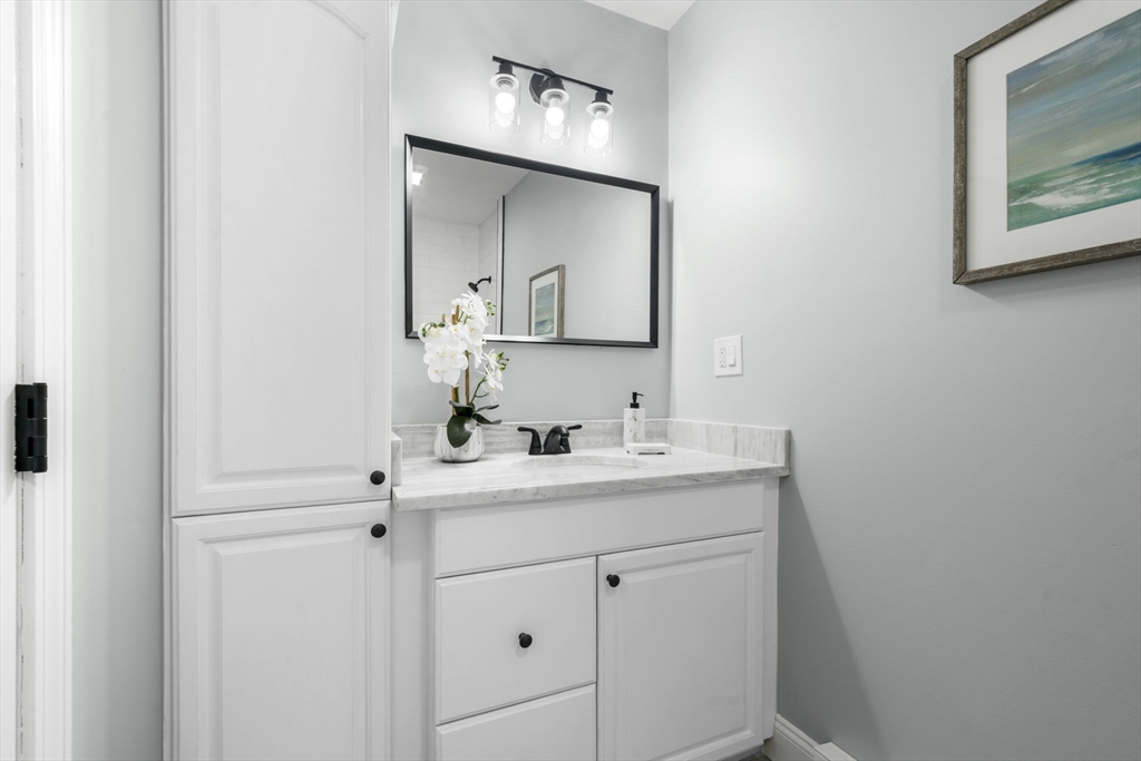 71 School Street, Unit 71 Acton, MA 01720 - Photo 19 of 38 a bathroom with a sink and a mirror