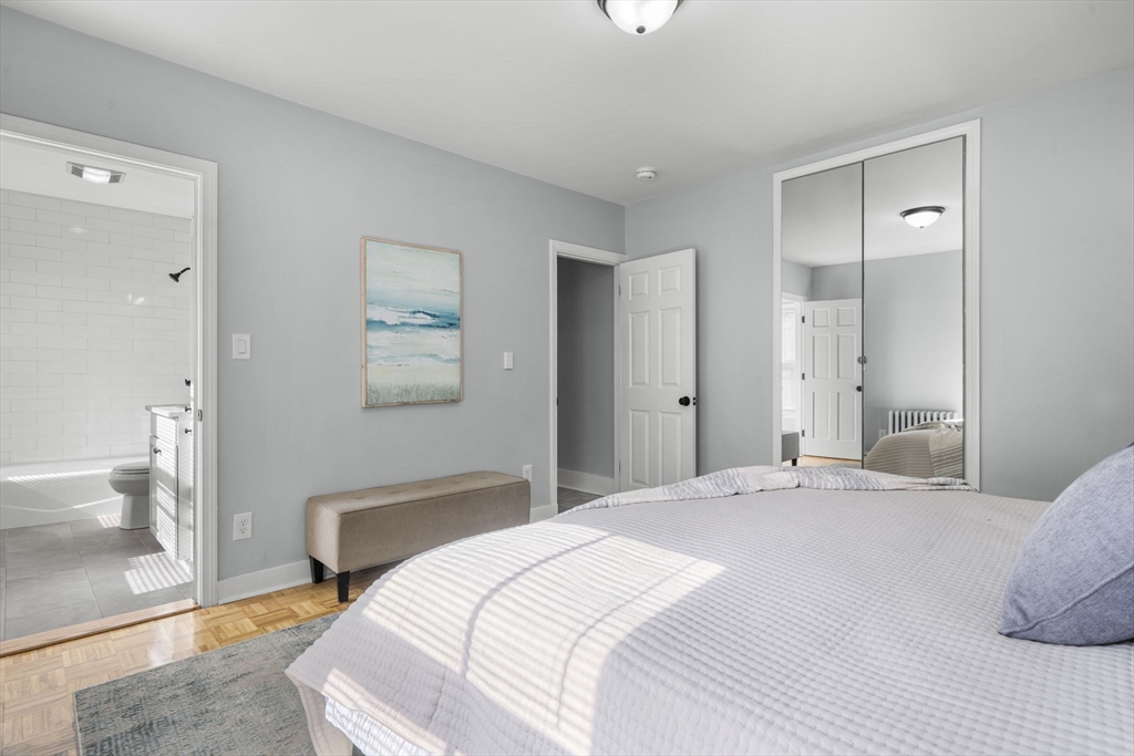 71 School Street, Unit 71 Acton, MA 01720 - Photo 22 of 38 a bedroom with a bed and a painting on the wall