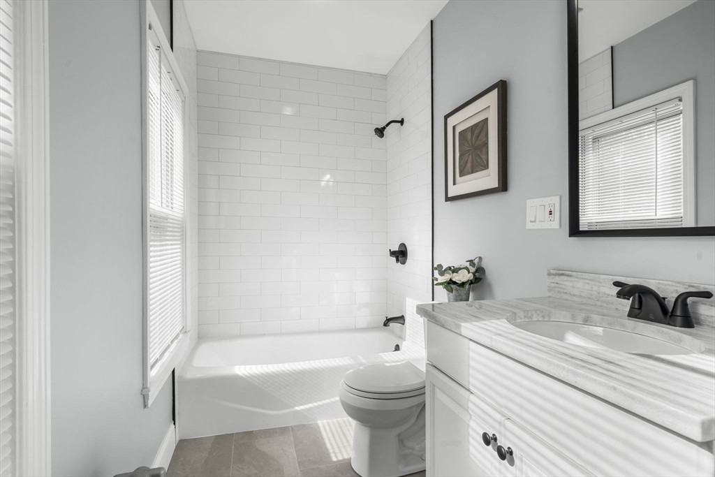 71 School Street, Unit 71 Acton, MA 01720 - Photo 24 of 38 a bathroom with a sink toilet a bathtub and shower