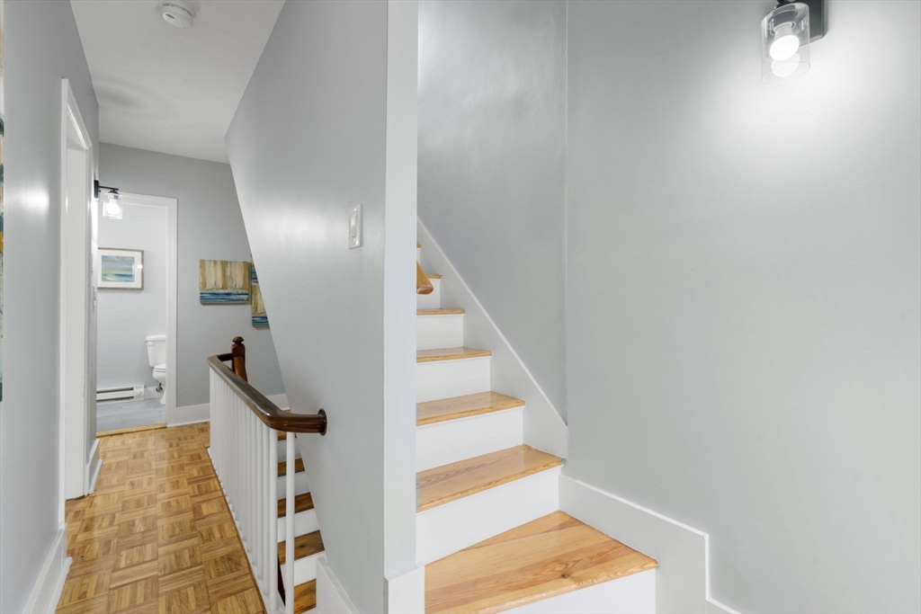 71 School Street, Unit 71 Acton, MA 01720 - Photo 28 of 38 a view of staircase with white walls and wooden floor