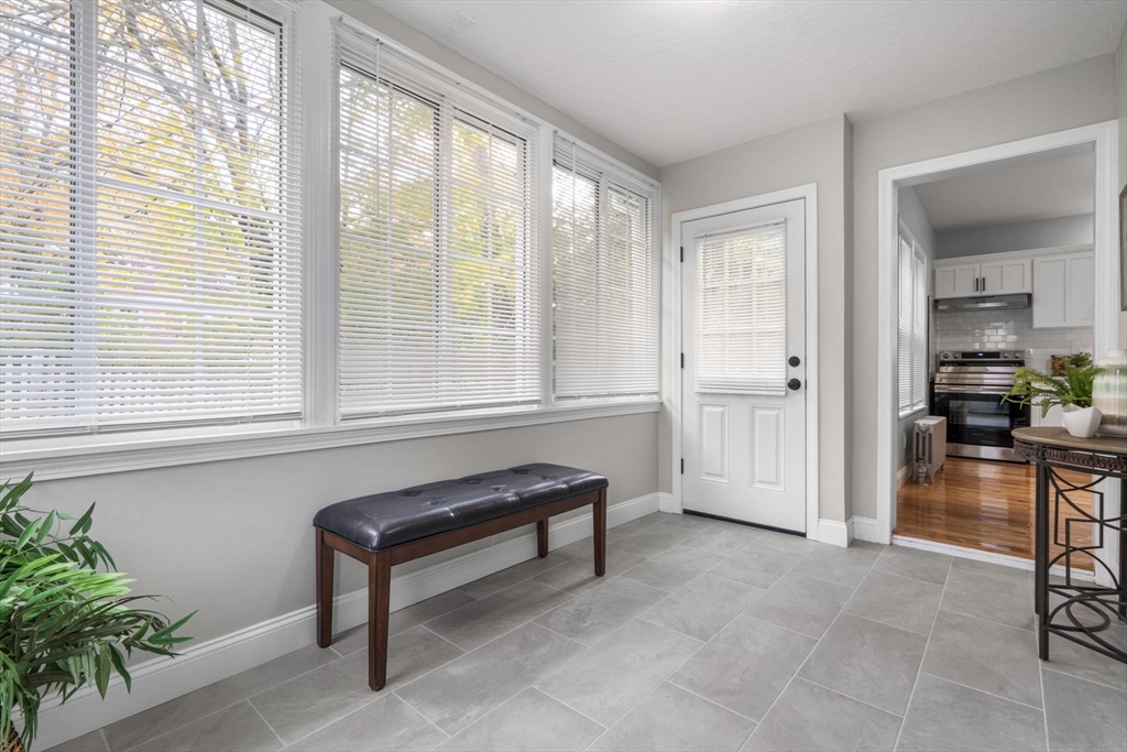 71 School Street, Unit 71 Acton, MA 01720 - Photo 5 of 38 a living room with furniture and a window