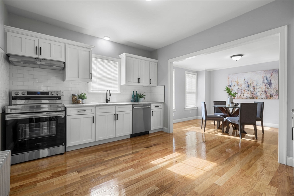71 School Street, Unit 71 Acton, MA 01720 - Photo 6 of 38 a kitchen with a stove a sink and a refrigerator
