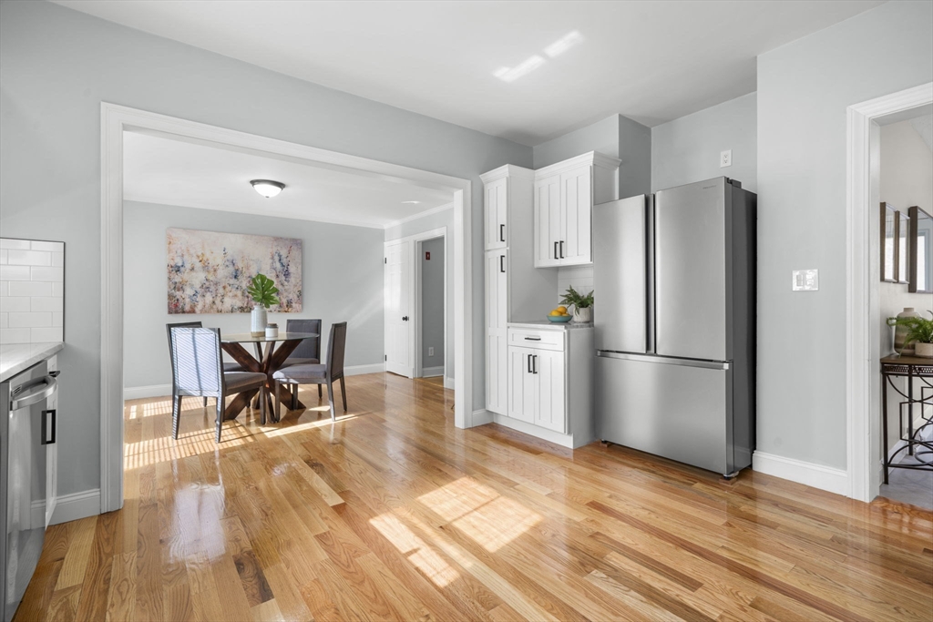 71 School Street, Unit 71 Acton, MA 01720 - Photo 7 of 38 a kitchen with stainless steel appliances a refrigerator and wooden floor