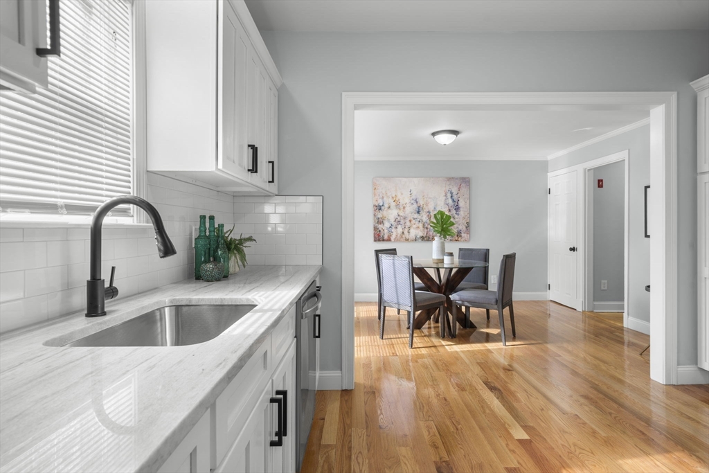 71 School Street, Unit 71 Acton, MA 01720 - Photo 9 of 38 a kitchen with a table chairs and entryway