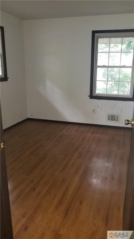 17 Ash Road Edison, NJ 08817 - Photo 13 of 19 an empty room with wooden floor and windows