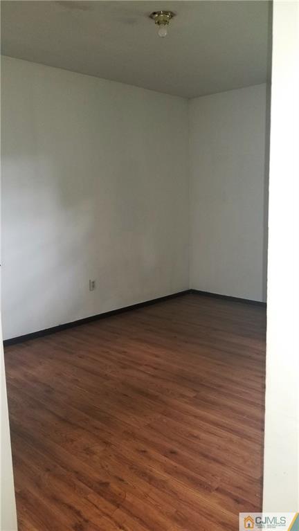 17 Ash Road Edison, NJ 08817 - Photo 14 of 19 a view of an empty room and wooden floor