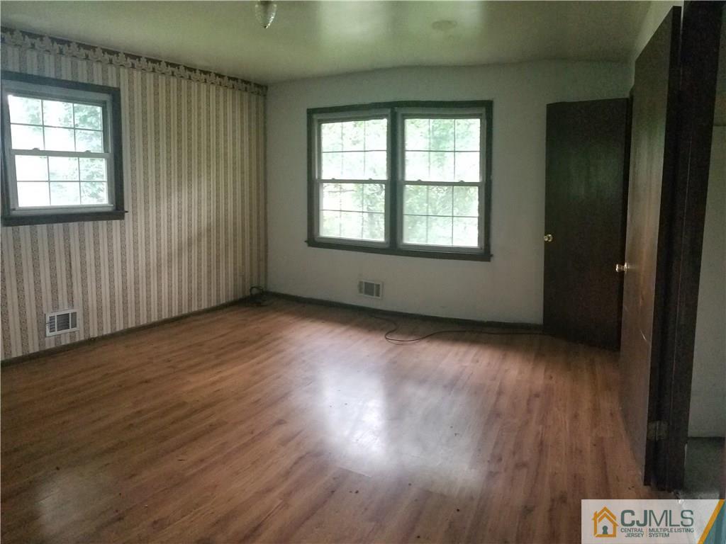 17 Ash Road Edison, NJ 08817 - Photo 15 of 19 an empty room with wooden floor and windows