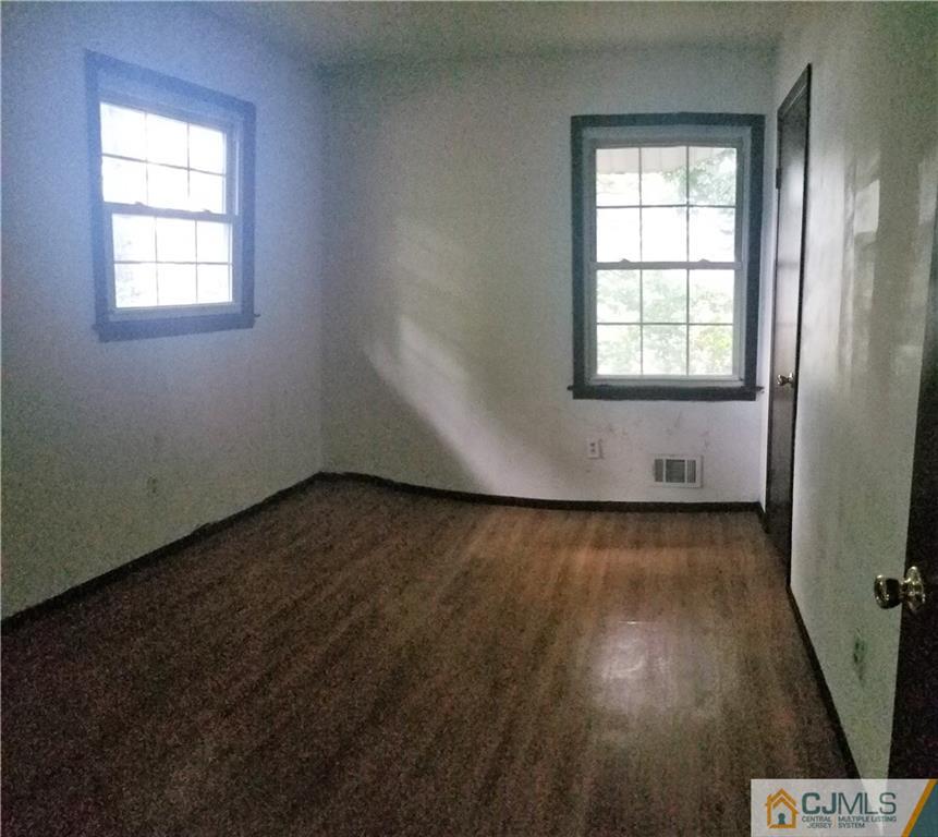17 Ash Road Edison, NJ 08817 - Photo 16 of 19 an empty room with wooden floor and windows