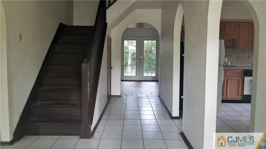 17 Ash Road Edison, NJ 08817 - Photo 3 of 19 a view of a hallway with wooden floor and entryway