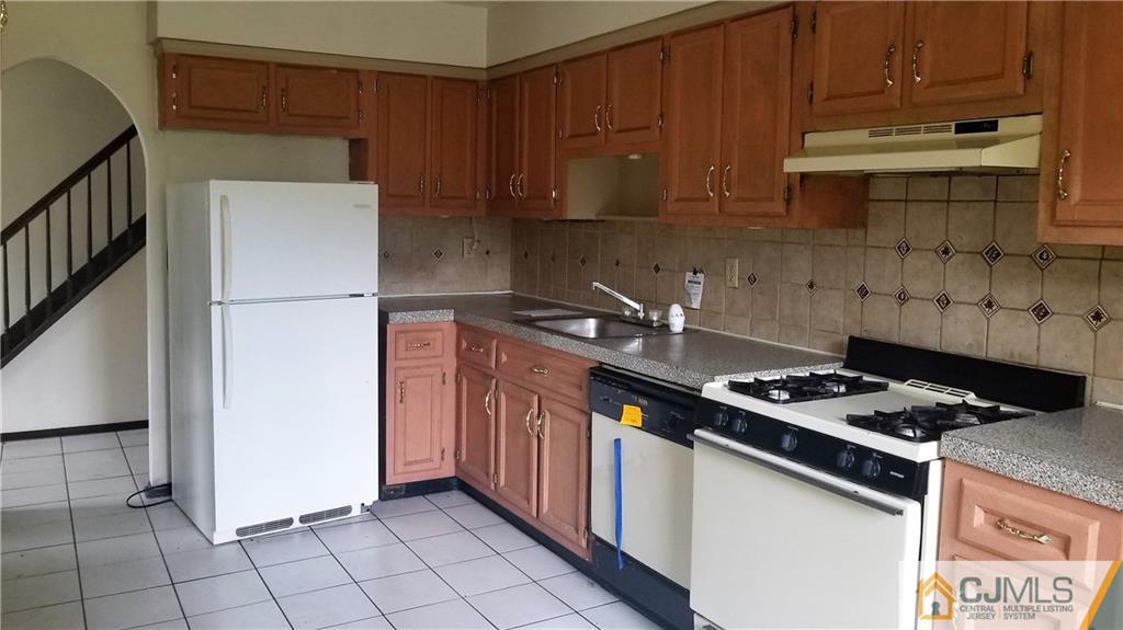17 Ash Road Edison, NJ 08817 - Photo 6 of 19 a kitchen with a stove and a refrigerator