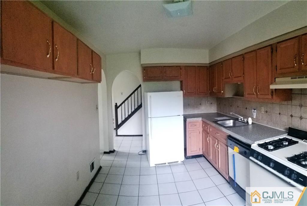 17 Ash Road Edison, NJ 08817 - Photo 7 of 19 a kitchen with stainless steel appliances granite countertop a stove a sink and a refrigerator
