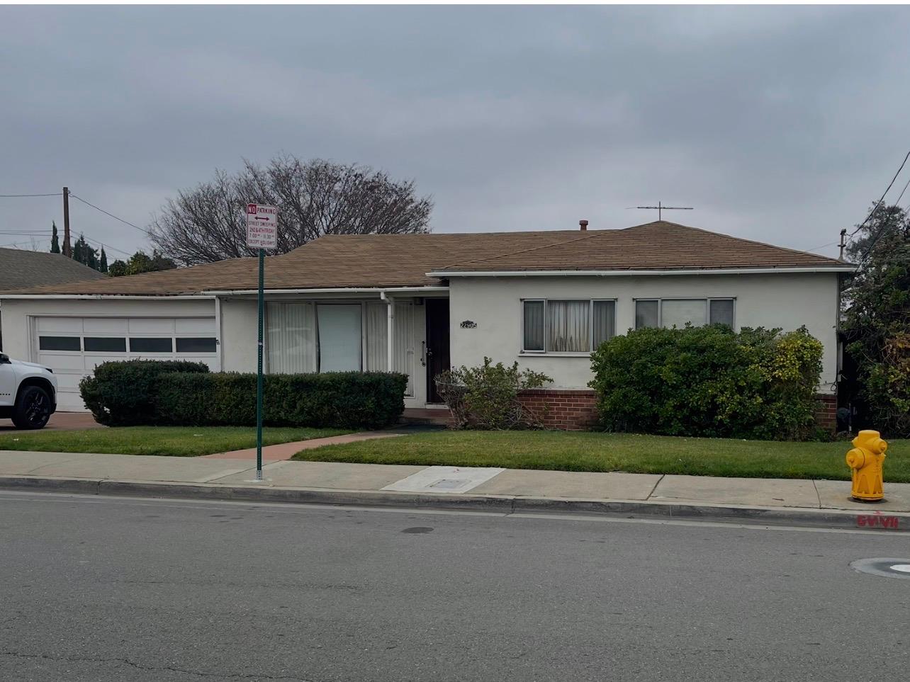 22905 Alice Street Hayward, CA 94541 - Photo 1 of 1 a front view of a house with a yard and garage