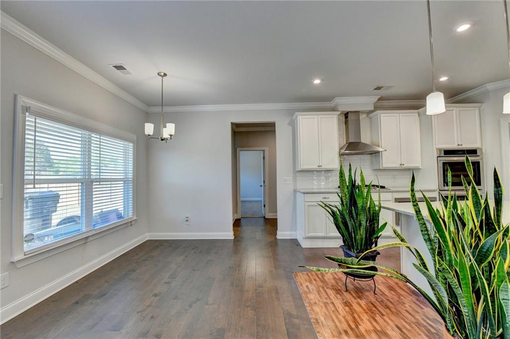4548 Red Blossom Trail Southwest Powder Springs, GA 30127 - Photo 21 of 72 a view of a room with potted plants and wooden floor