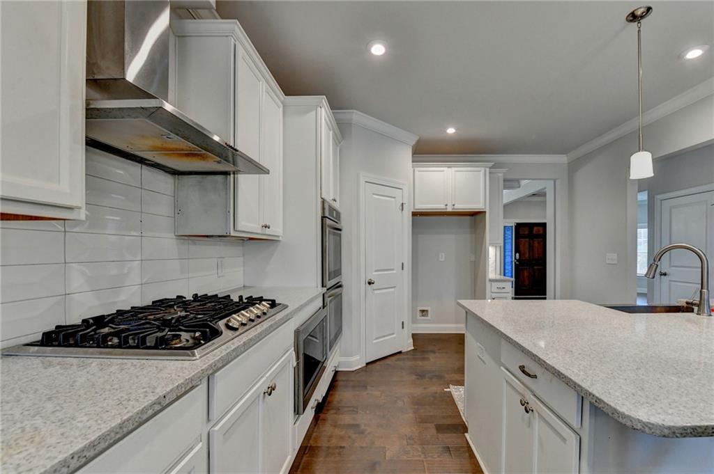 4548 Red Blossom Trail Southwest Powder Springs, GA 30127 - Photo 23 of 72 a kitchen with stainless steel appliances a sink a stove and a refrigerator