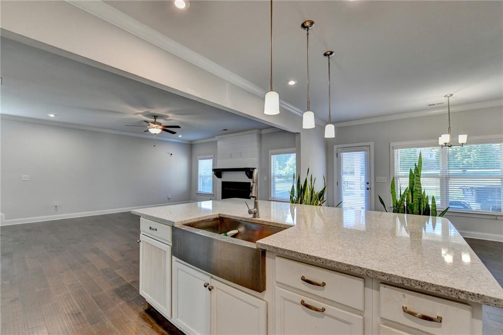 4548 Red Blossom Trail Southwest Powder Springs, GA 30127 - Photo 24 of 72 a kitchen with a stove cabinets and wooden floor