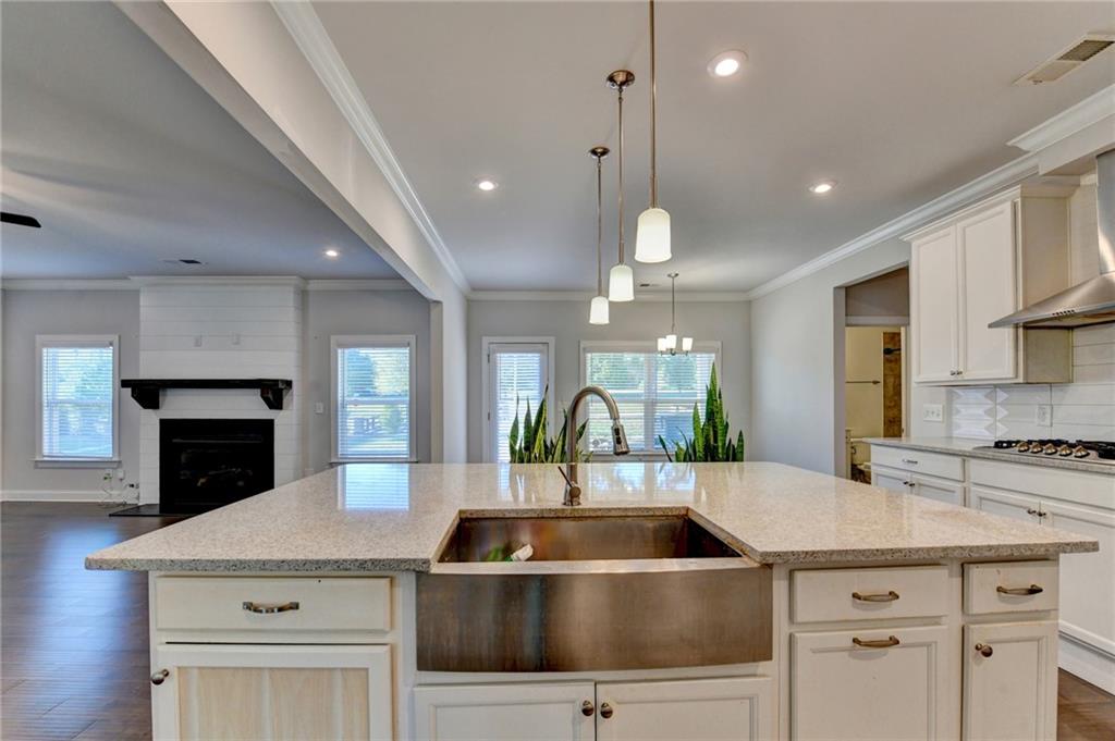 4548 Red Blossom Trail Southwest Powder Springs, GA 30127 - Photo 25 of 72 a kitchen with kitchen island a sink stainless steel appliances and cabinets